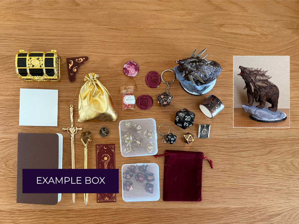 Leviathan's Trove Mystery Box contents arranged on a wooden tabletop, including a small gold-and-black treasure chest, crystals, a dark metallic figurine, dice, a notebook, rods, a velvet pouch, and a central purple banner reading 'LEVIATHAN'S TROVE MYSTERY BOX'.